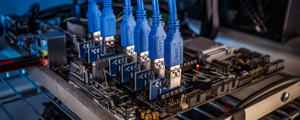 Cryptocurrency mining rig PCIe riser extenders plugged to motherboard
